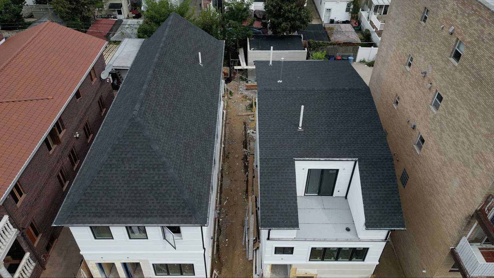 Overhead drone view of two matching Brooklyn duplex roofs