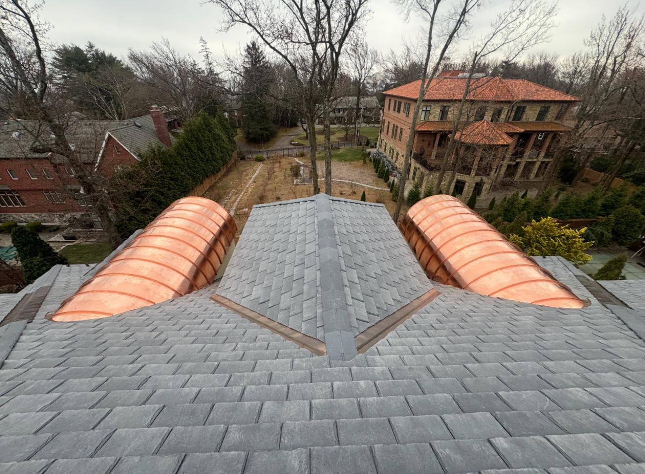 Close view of copper barrel dormers on slate roof