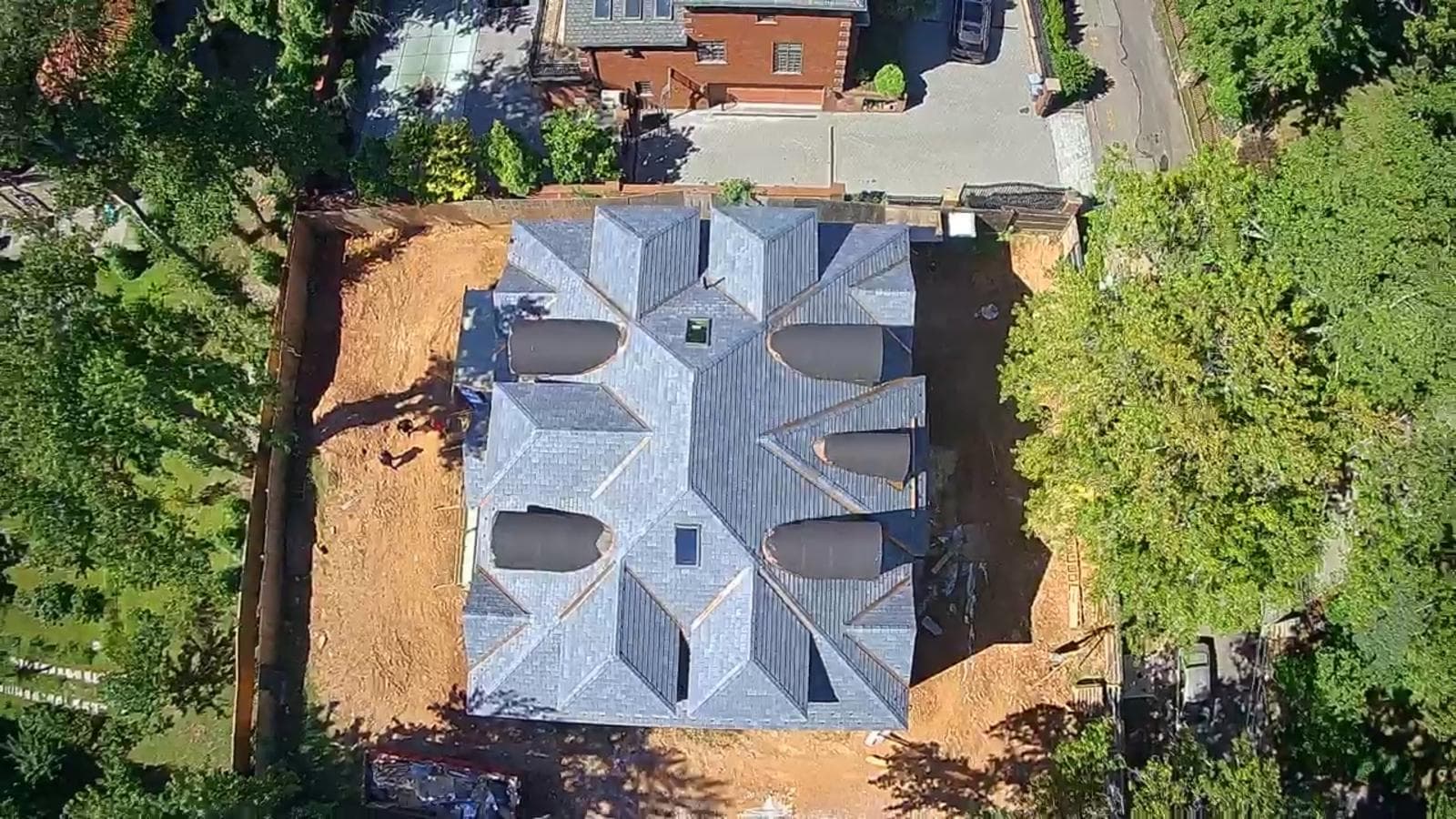 Top-down drone view of completed slate and copper roof